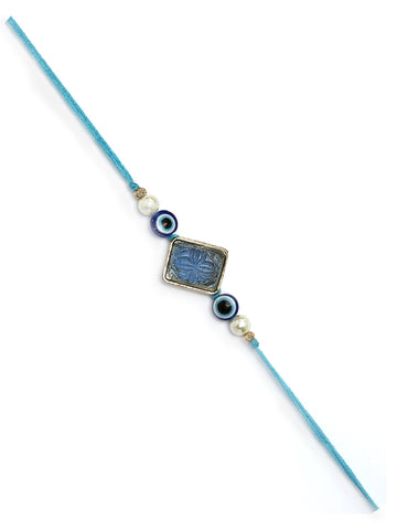 Karatcart Gold Plated Blue Carved Stone Evil Eye Kundan Bhiya Rakhi with Roli & Chawal