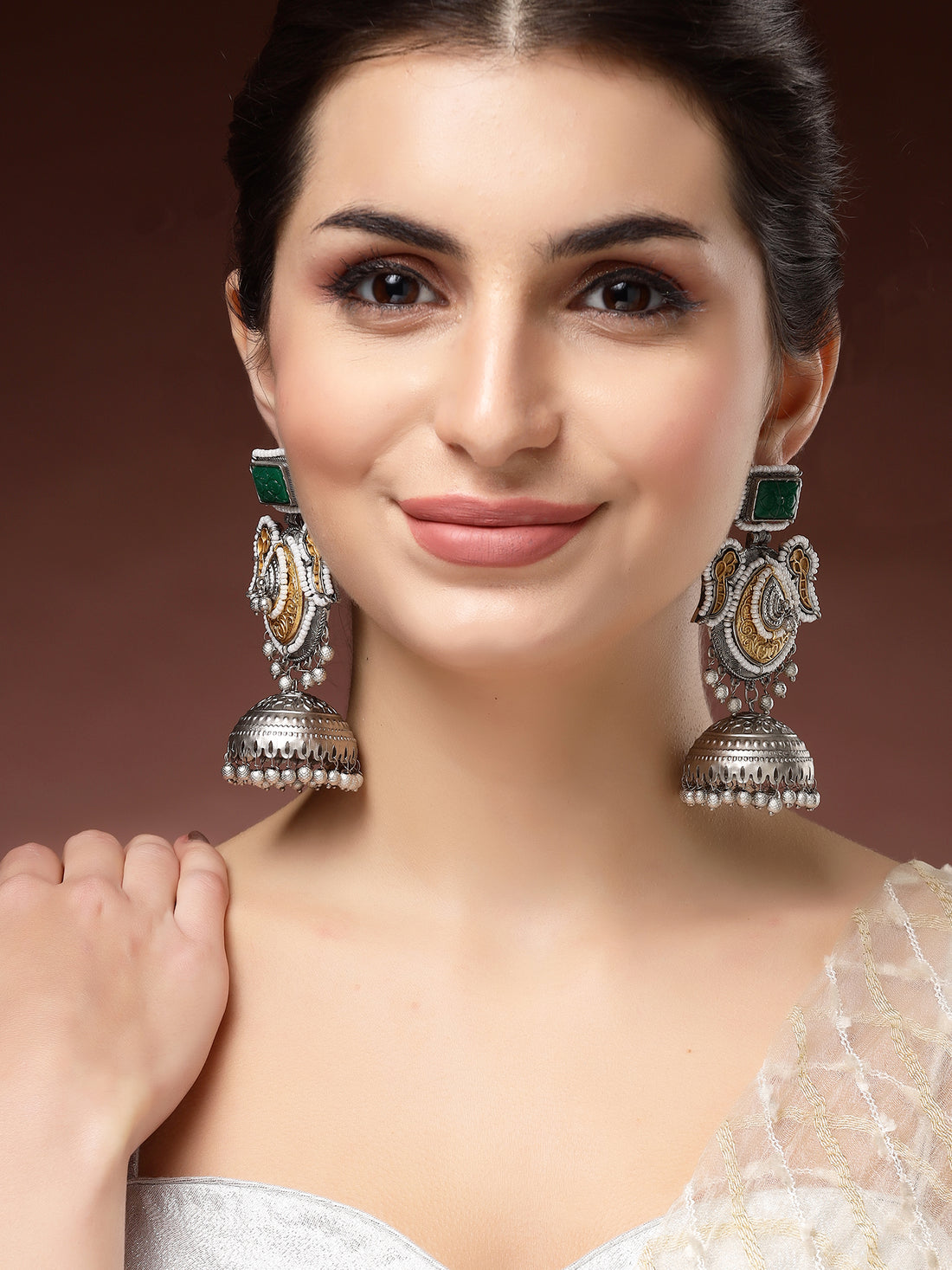 Karatcart Classic Silver and Gold-Plated Jhumka Earrings with Green Carved Stone