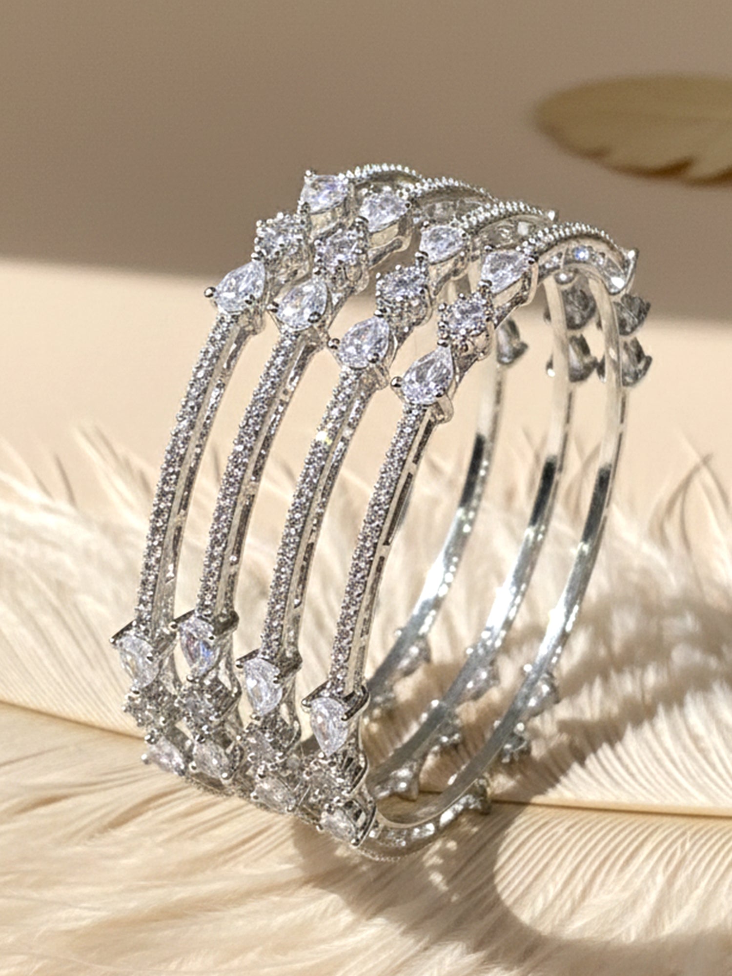 KARATCART Designer Set of 4 Silver Plated American Diamond Bangles for