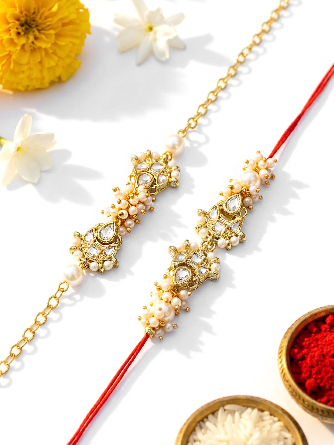 KARATCART Set of 2 Gold Plated Pearl Handmade Kundan Bhaiya Bhabhi Rakhi Combo with Roli & Chawal