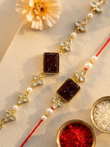 KARATCART Set of 2 Gold Plated Red Carved Stone Kundan Handmade Bhaiya Bhabhi Rakhi Combo with Roli & Chawal