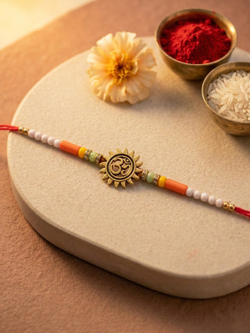 KARATCART Gold Plated Om Sun Design Beaded Bhaiya Rakhi with Roli & Chawal