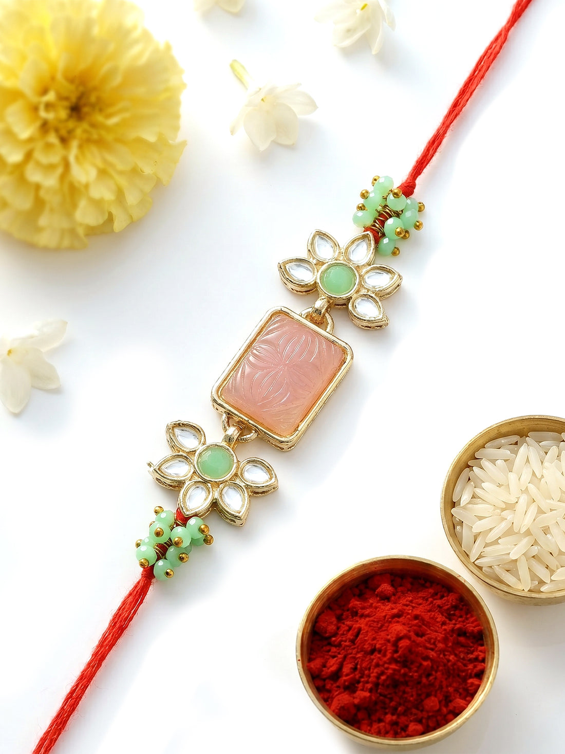 KARATCART Beautiful Pink Carved Stone & Lime Green Crystal Kundan Rakhi for Brother with Roli Chawal