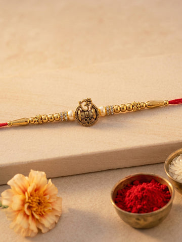 KARATCART Gold Plated Om and Shiv Damru Rakhi for Bhaiya with Roli & Chawal