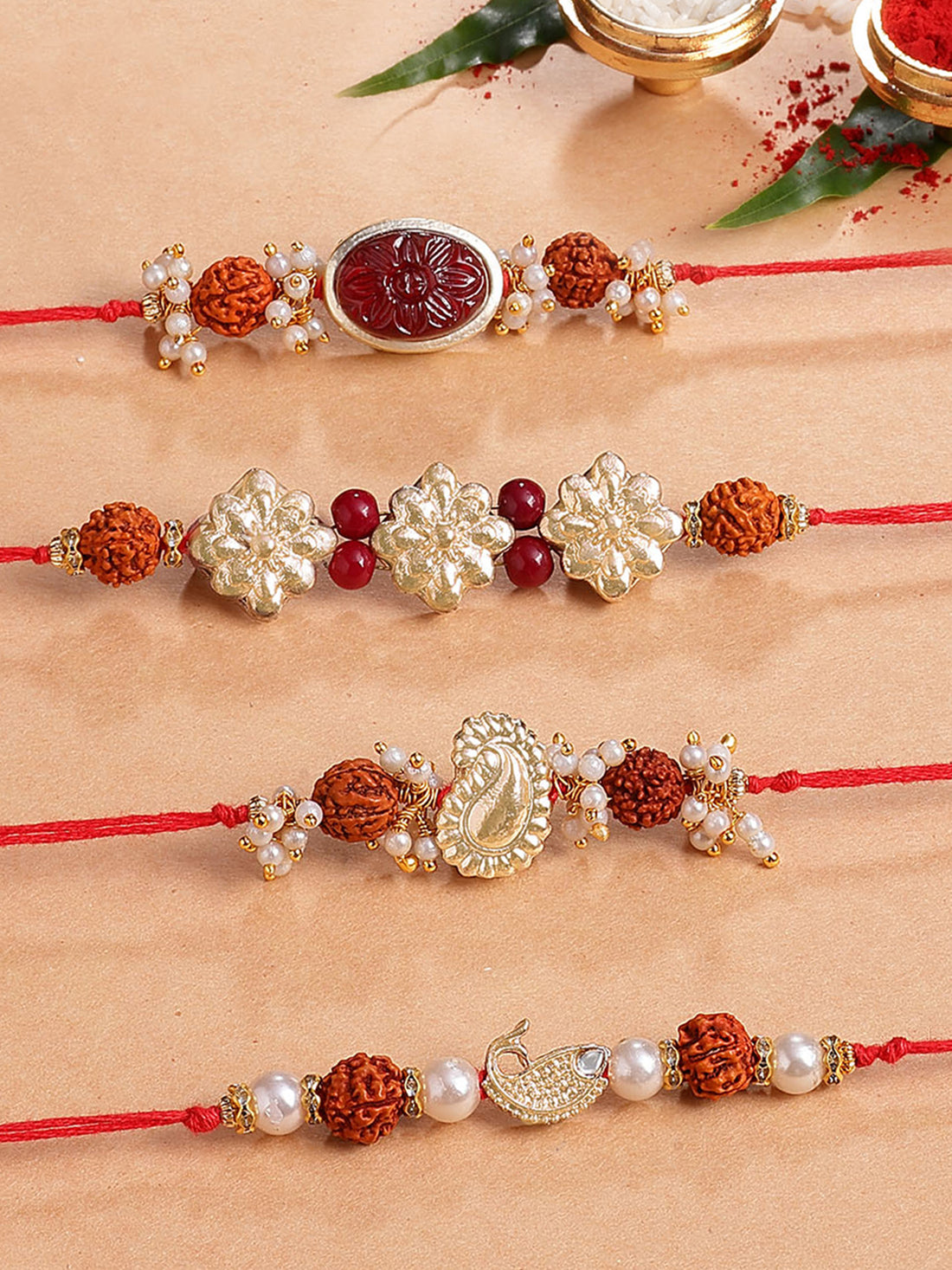 Karatcart Set of 4 Red Carved Stone and Rudraksha Kundan Rakhi for Brother with Roli & Chawal