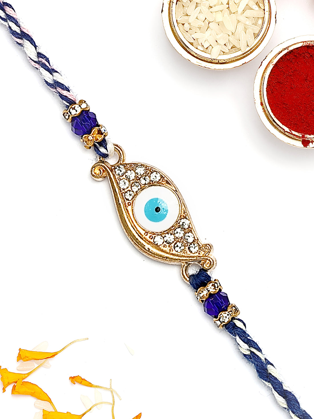 KARATCART Gold Plated Blue American Diamond Eye Shape Evil Eye Bhaiya Rakhi with Roli & Chawal