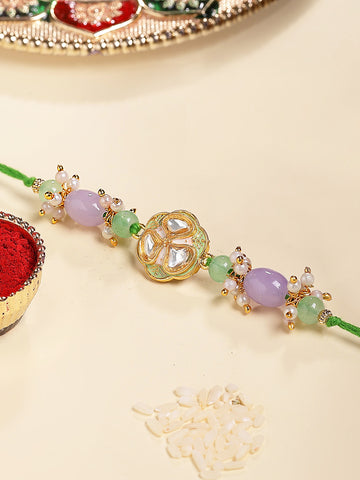 KARATCART Gold Plated Purple and Green Beads Kundan Bhaiya Rakhi with Roli & Chawal