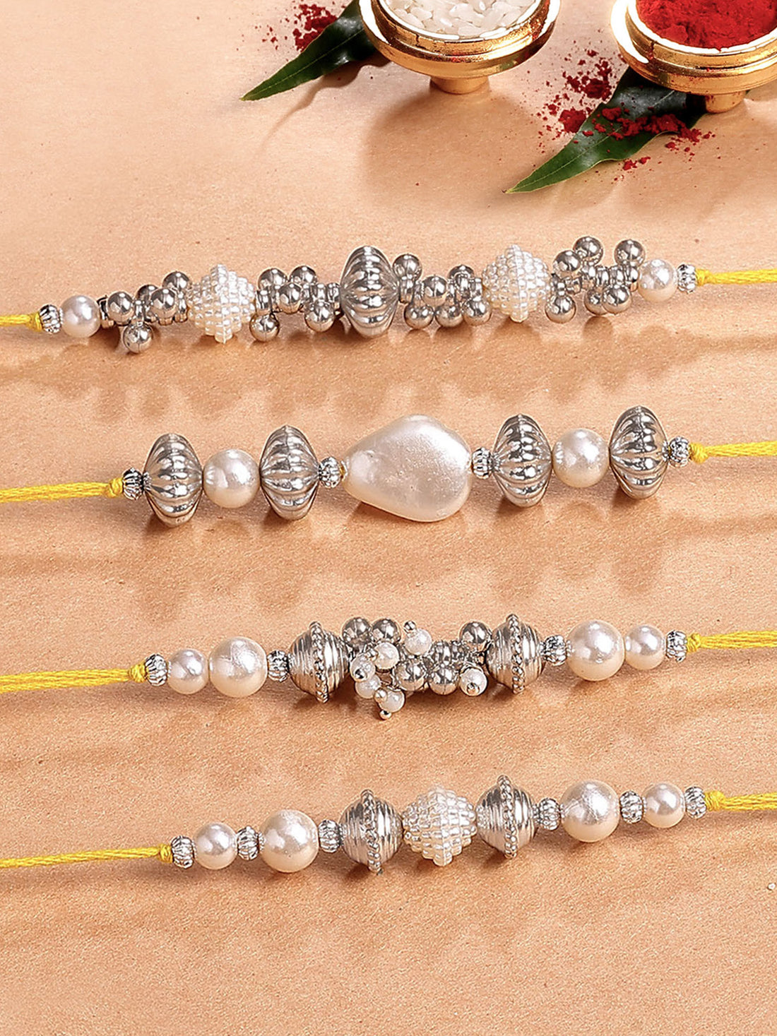 Karatcart Set of 4 Silver Beads and Pearl Kundan Rakhi for Brother with Roli & Chawal