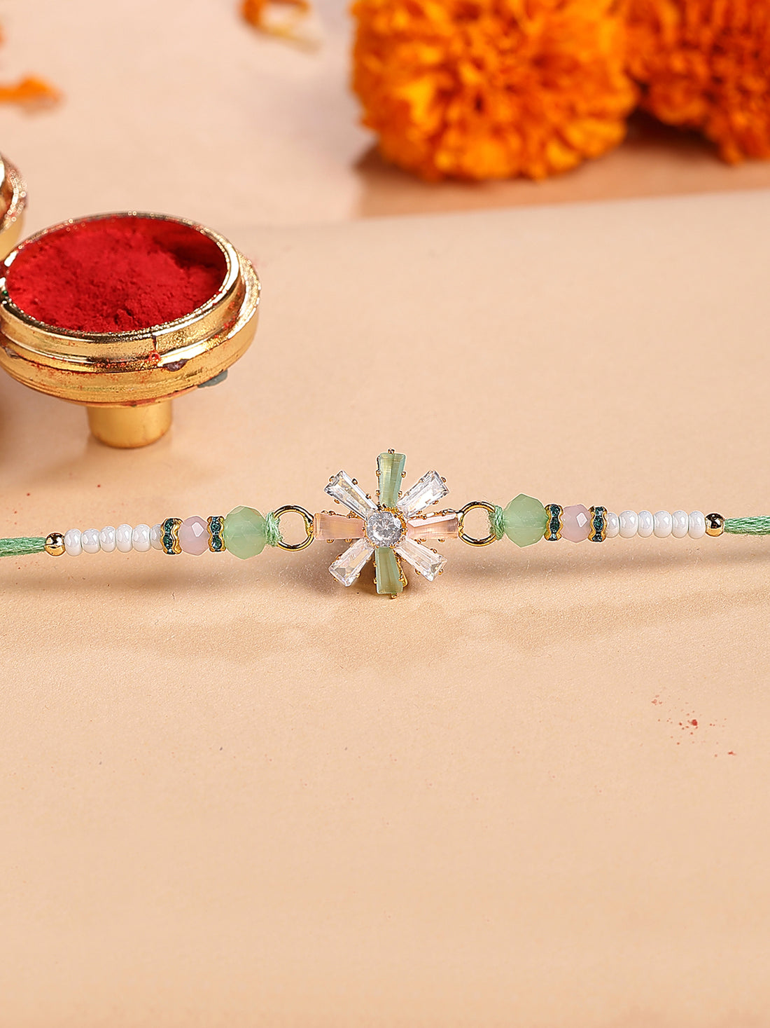 Karatcart Peach and Lime Green Rhinestones Floral Bhiya Rakhi with Roli & Chawal