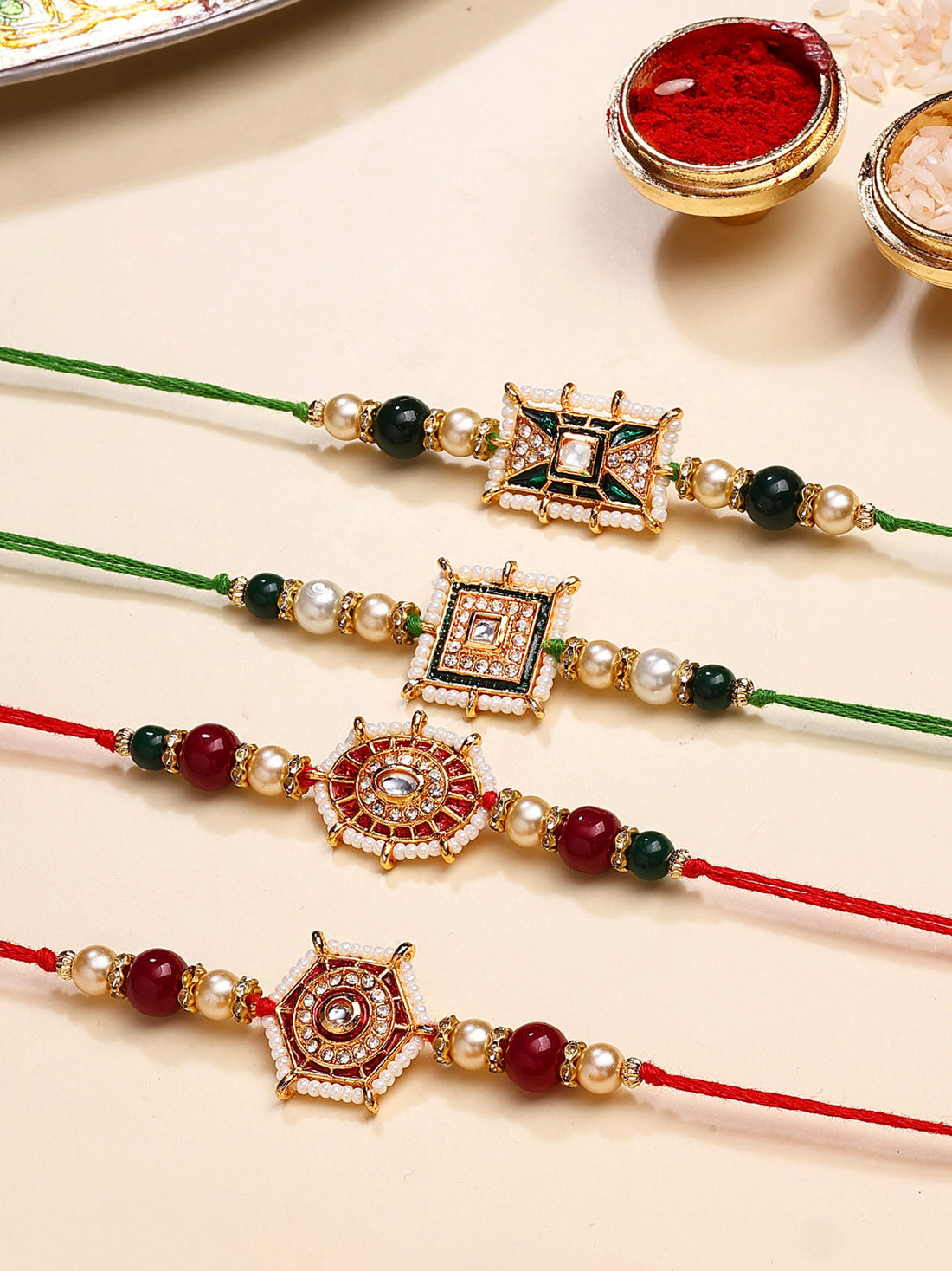Karatcart Set of 4 Red and Green Floral Design Kundan Rakhi for Brother with Roli & Chawal