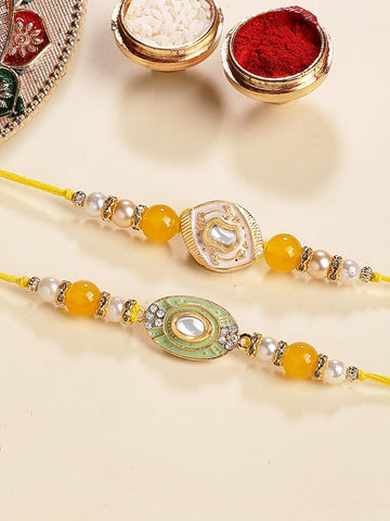 KARATCART Set of 2 White and Light Green Enamel Kundan Rakhi for Brother with Roli & Chawal