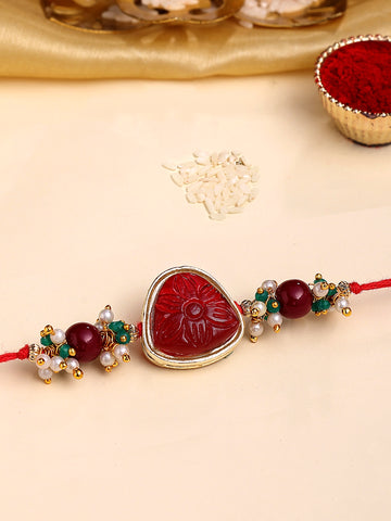KARATCART Gold Plated Red Carved Stone Kundan Bhaiya Rakhi with Roli & Chawal