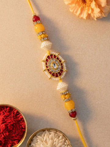 KARATCART Gold Plated Red and Yellow Sun Design Kundan Bhaiya Rakhi with Roli & Chawal