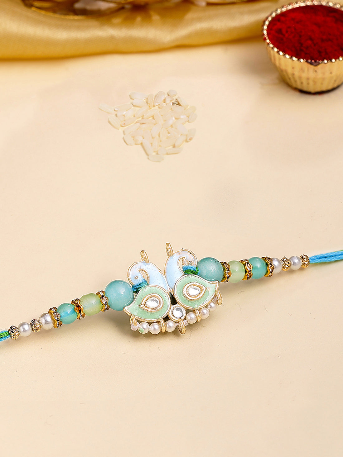 Karatcart Gold Plated Light Blue and Green Meena Kundan Bhiya Rakhi with Roli & Chawal