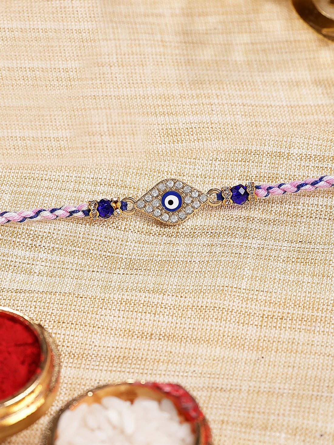 Karatcart Gold Plated Blue American Diamond Evil Eye Bhiya Rakhi with Roli & Chawal
