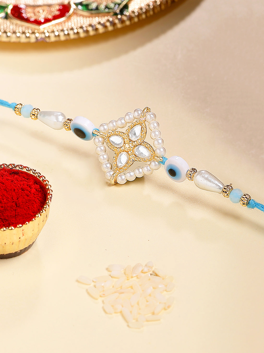 Karatcart Blue Evil Eye and Pearl Kundan Rakhi for Brother with Roli & Chawal