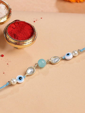 KARATCART Gold Plated Light Blue Bead Evil Eye Kundan Bhaiya Rakhi with Roli & Chawal
