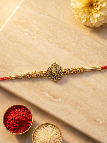 KARATCART Gold Plated Ganpati Face Paan Leaf Designer Bhaiya Rakhi with Roli & Chawal