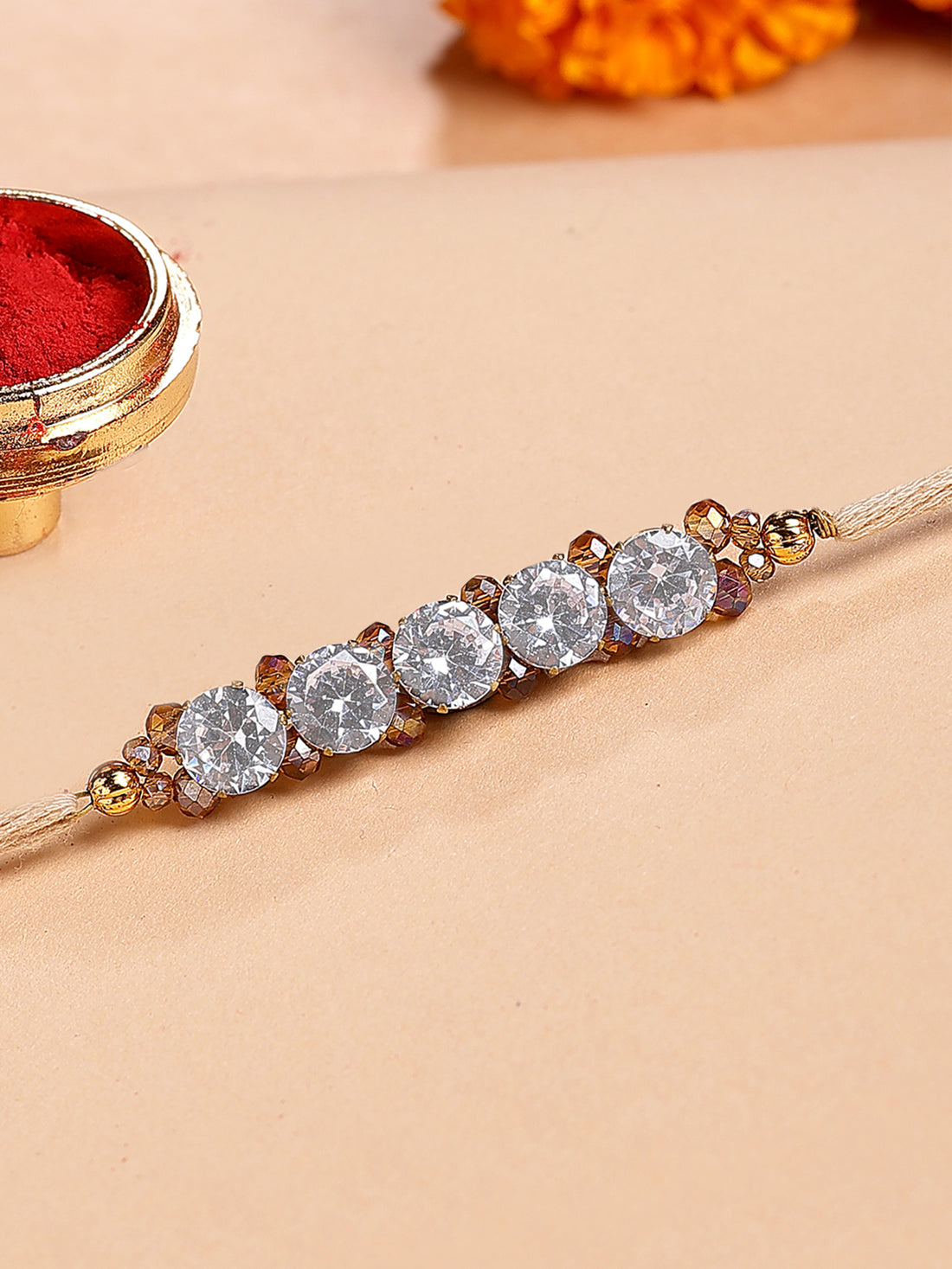 Karatcart Brown Crystal and Rhinestones Bhiya Rakhi with Roli & Chawal