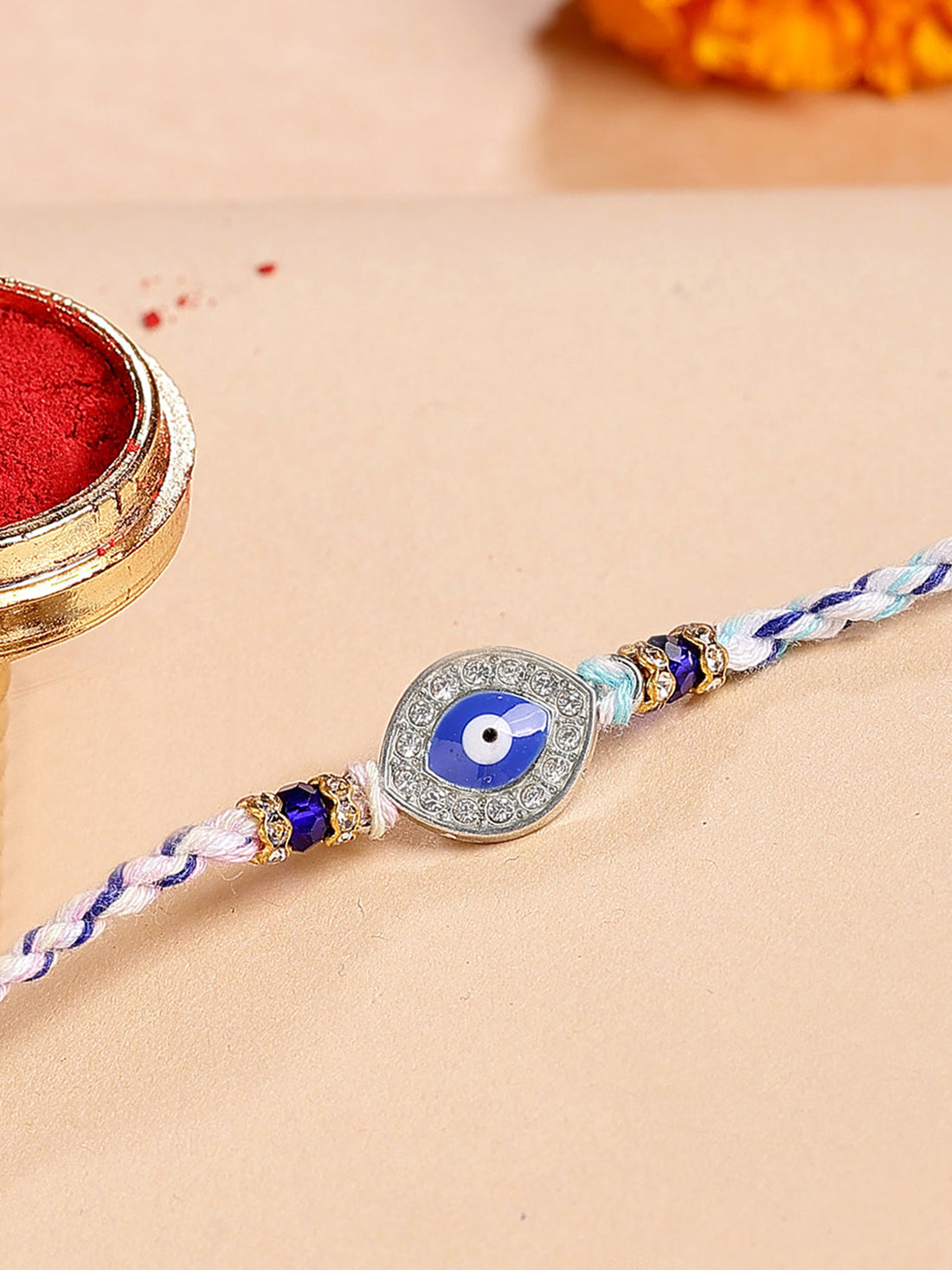 Karatcart Silver Plated Blue Evil Eye and American Diamond Bhiya Rakhi with Roli & Chawal