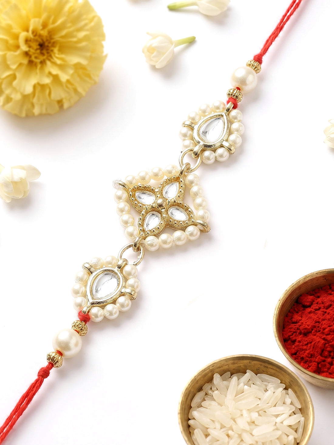 KARATCART Traditional Gold Plated Floral Design Handmade Kundan Rakhi for Brother with Roli Chawal