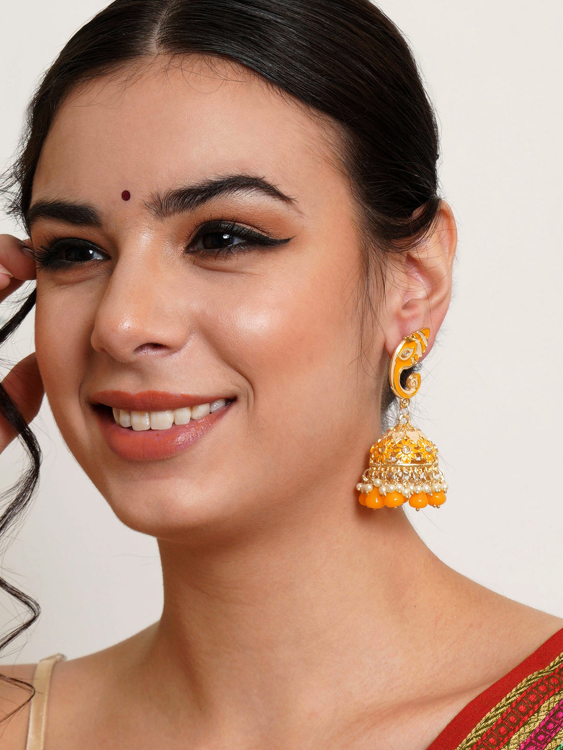 Karatcart Gold Plated Yellow Lord Ganesha Jhumki Earrings for Women