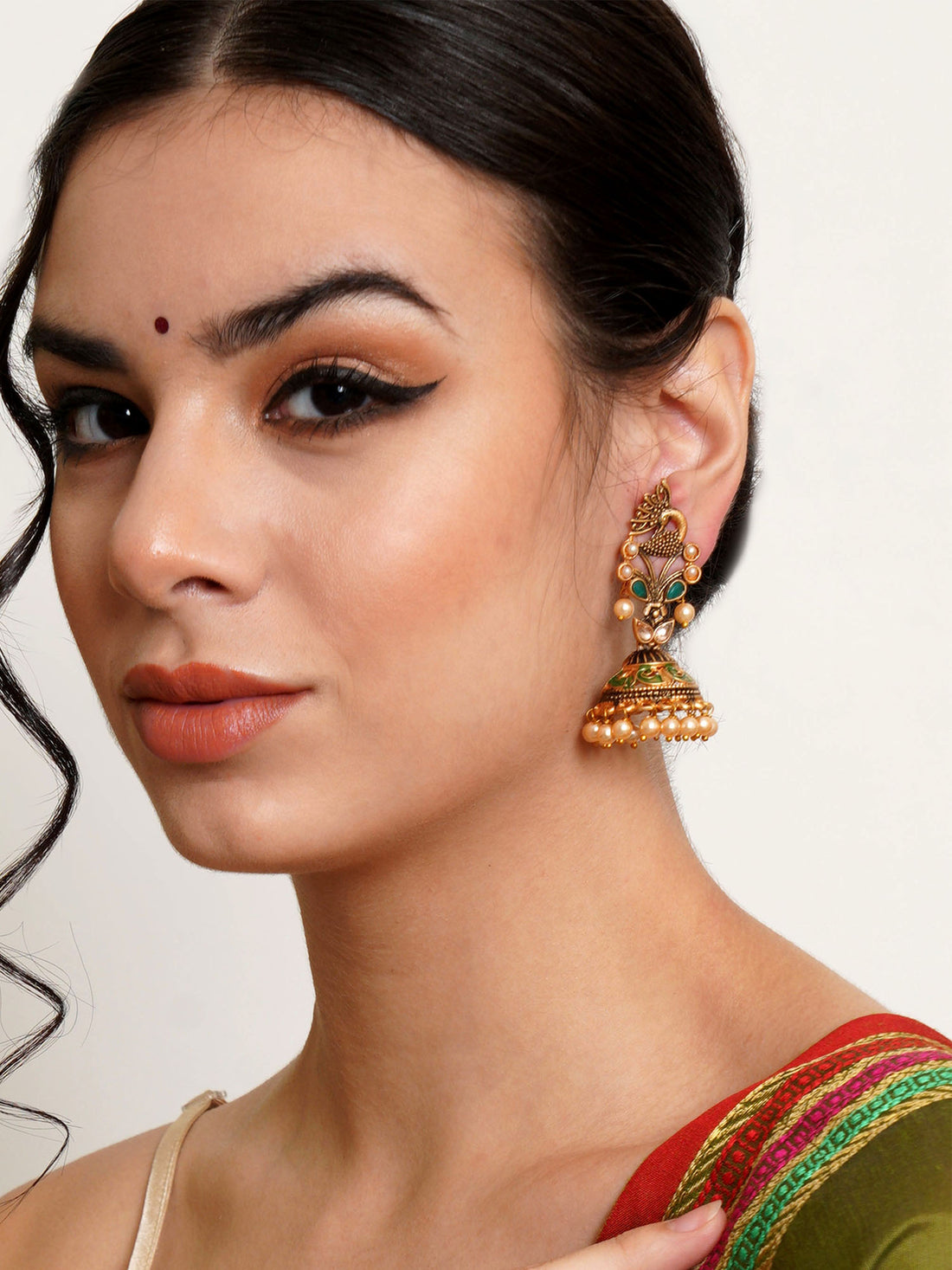 Karatcart Gold Plated Green Stone Studded Peacock Shape Jhumki Earrings for Women