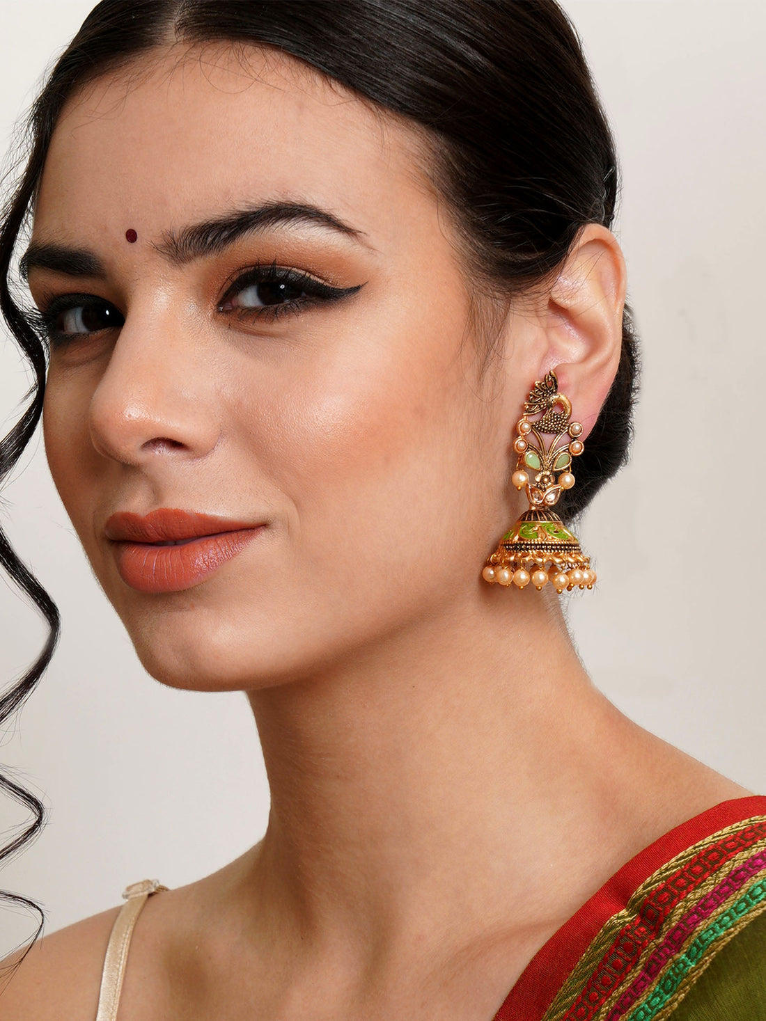 Karatcart Gold Plated Light Green Stone Studded Peacock Shape Jhumki Earrings for Women